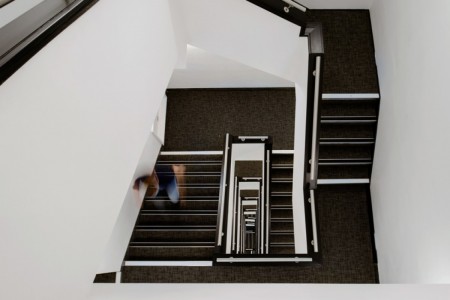 Prudential Buildings, Bristol - stairwell with dark carpet and white walls 