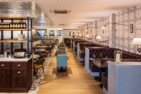 Wildwood, Crawley - seating area with brown leather booth seating, wooden floor and mosaic tile floor 