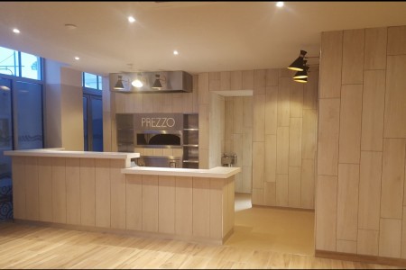 Prezzo, Mumbles - light tiled walls and wooden floor, branding on the wall