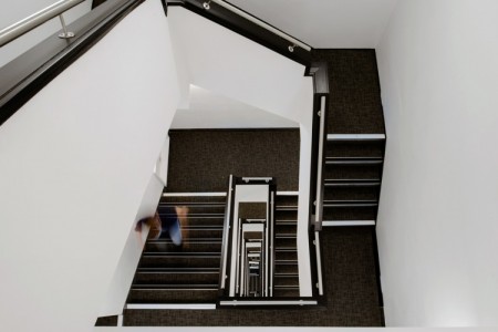 Prudential Buildings, Bristol - stairwell with dark carpet and white walls 