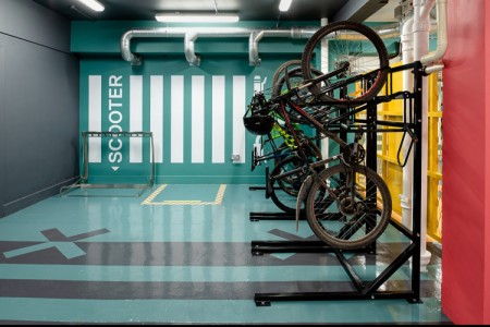 Prudential Buildings, Bristol - teale floor and wall with scooter parking area and bike rack to the right with bikes in