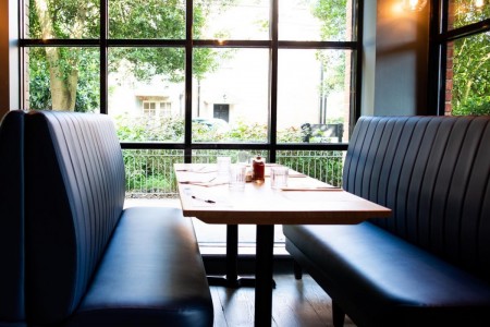 two padded dining benches and table