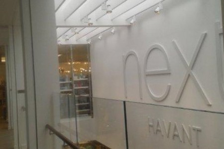 Next, Havant - white Next branding on a wall