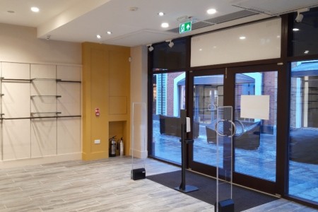 Joules, Cannock - empty store with dark wooden entrance doors, light wooden flooring, yellow wall details