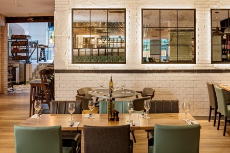 Wildwood, Crawley - white painted brickwork, blue and brown leather chairs around wooden tables 