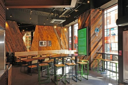 Shake Shack, New Oxford Street, London - wooden clad walls, wooden stools, chairs and tables