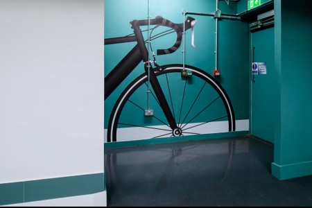 Prudential Buildings, Bristol - teale and white walls with black bike graphic