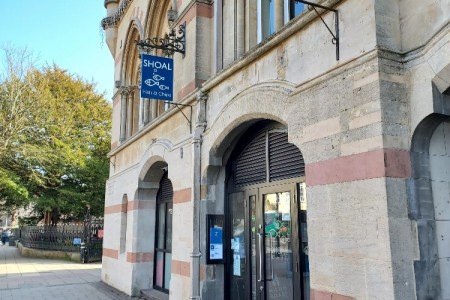 Street view of building with Shoal logo