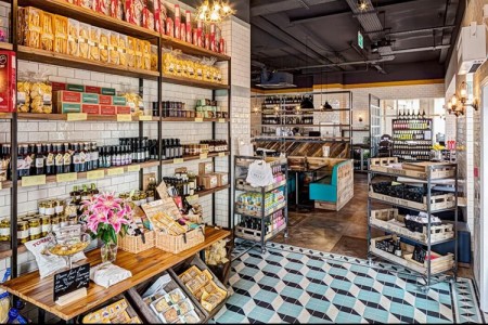 Wildwood, Braintree - interior shop area with jars and boxes on a wooden display, blue and white mosaic flooring 