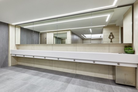 Princesshay Shopping Centre public toilets, Exeter - beige tiling on walls, large mirror, grey floor tiling, long communal sink(s)