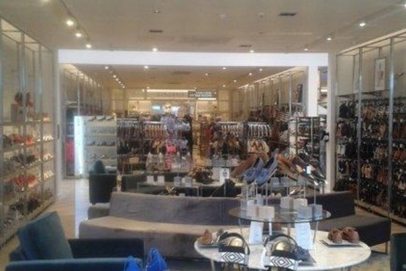 Next, Havant - shoe area with grey and blue sofas, surrounded by shoe displays