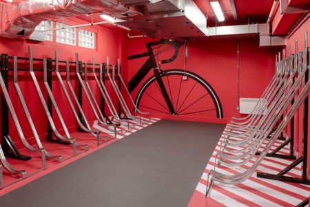 Prudential Buildings, Bristol - bicycle storage on both sides with red walls and black graphic depicting a bike on the wall