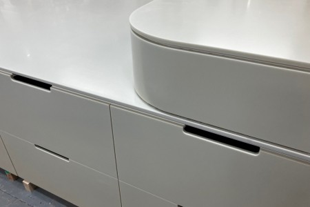 Made of High Macs, a solid surface material, which creates a seamless, sleek finish on this mid floor unit for a high-end retailer in Knightsbridge.