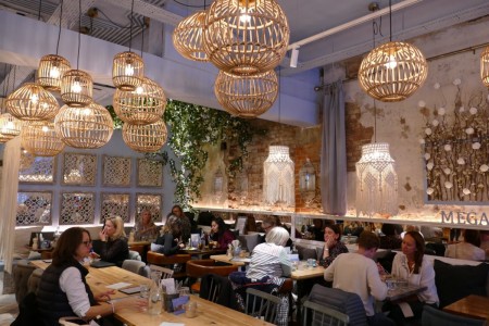 Megan's, Wimbledon - customers sat at tables with low lighting, unique wooden and white macrame lampshades, chic decor