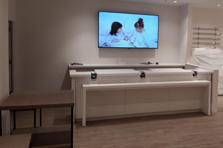 The White Company, Windsor - till area with card machines, tv behind desk, white walls, wooden floor